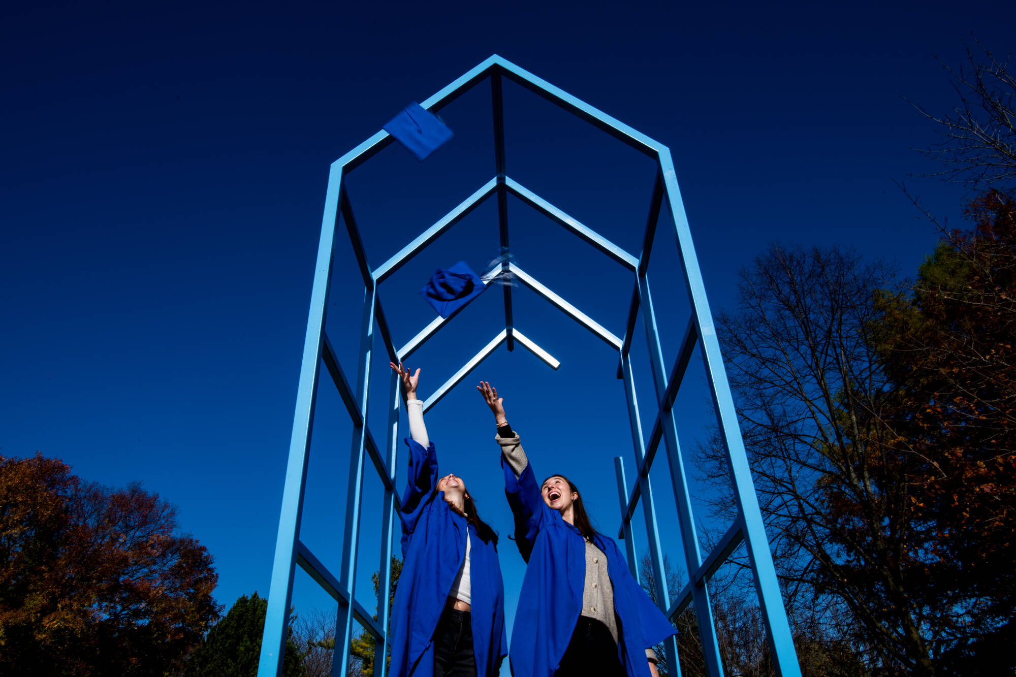 Friends Madison Dombrowski, left, and Ava Tomas pose for a graduation photo near the Transformational Link on the Allendale Campus November 8. The two will walk in the Commencement ceremony on December 7.
